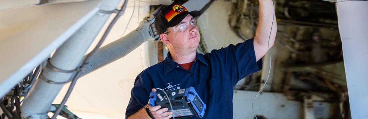 An Aviation student runs tests on an aircraft in the Pima's Aviation Center